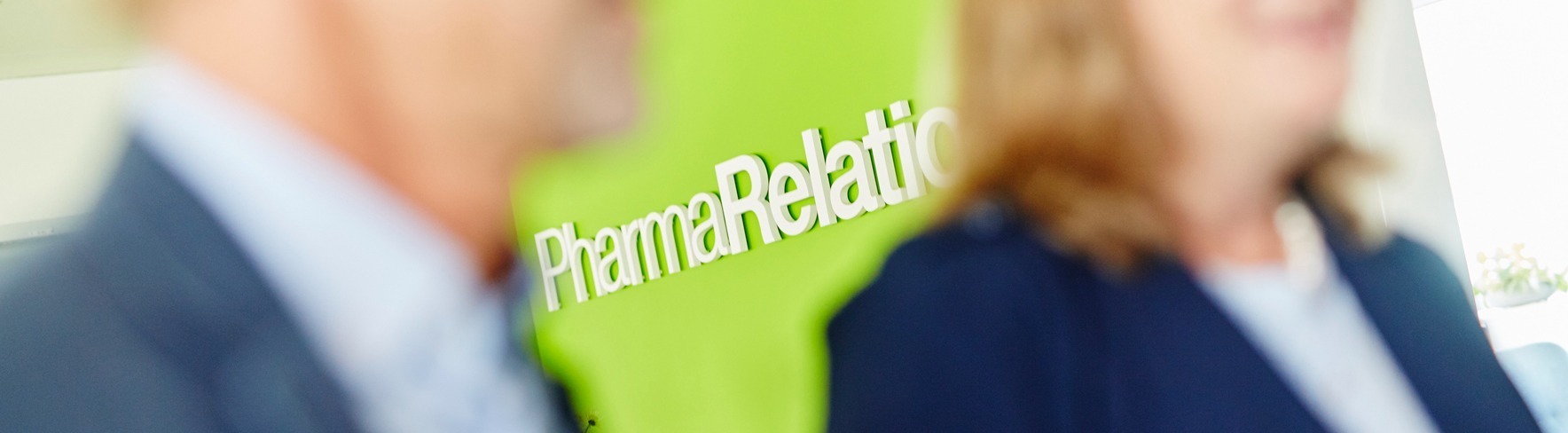 PharmaRelations blured colleagues focused wall