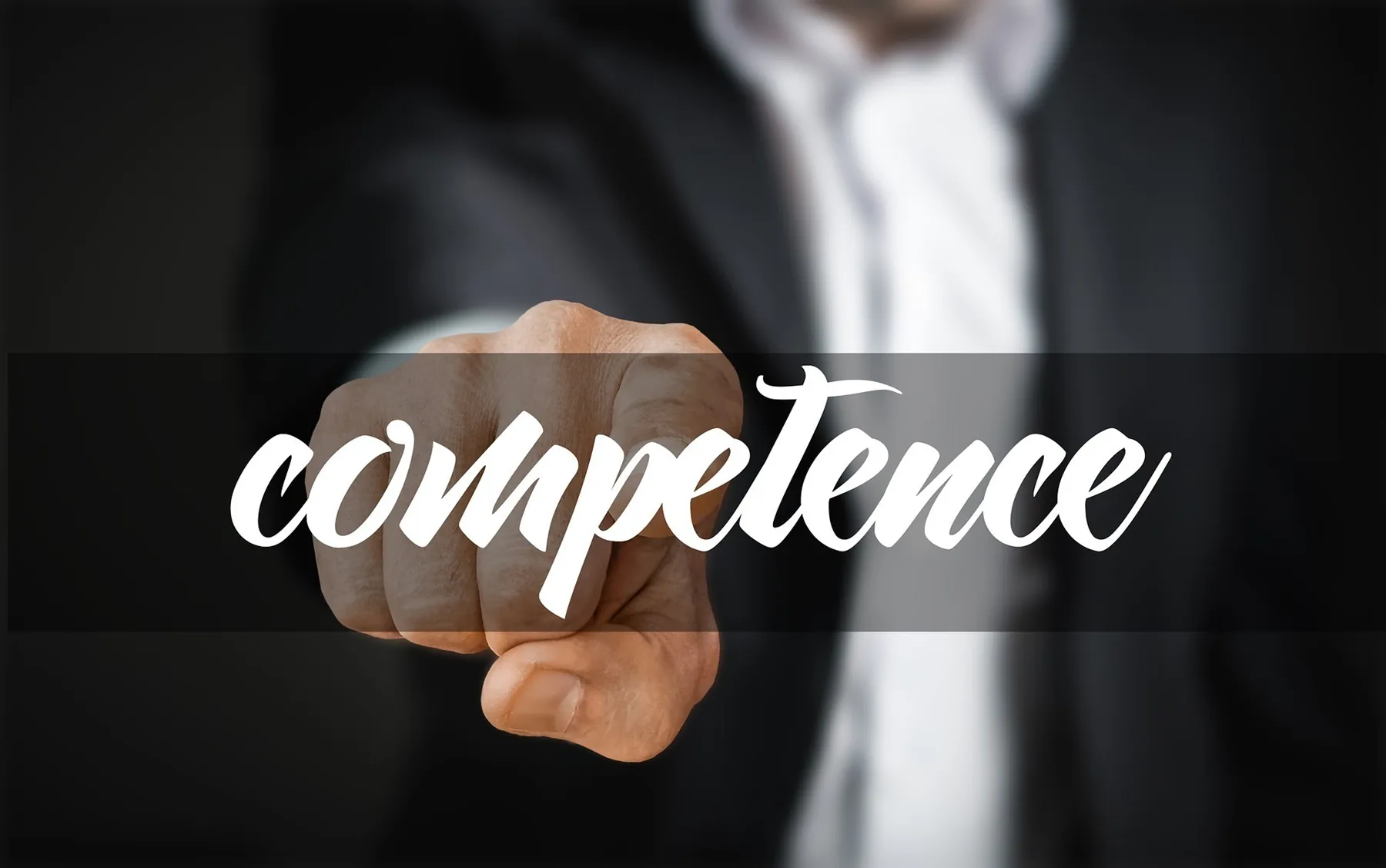 hand pointing to the word competence
